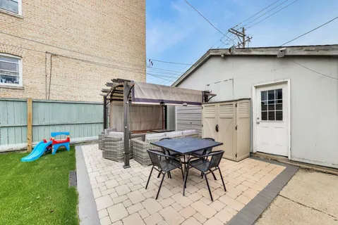 a view of a patio with table and chairs and potted plants