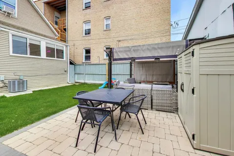a view of a backyard with a table and chairs