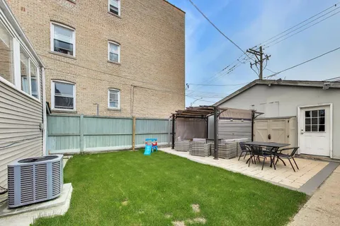 a view of a backyard with table and chairs