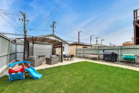 a swimming pool with outdoor seating and yard