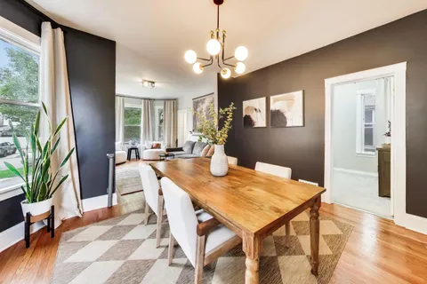 a view of a dining room with furniture and a potted plant