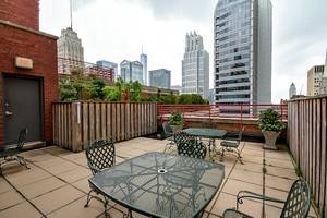 208 West Washington Street, Unit 1002 Chicago, IL 60606 - Photo 15 of 16 a view of a patio with a table and chairs