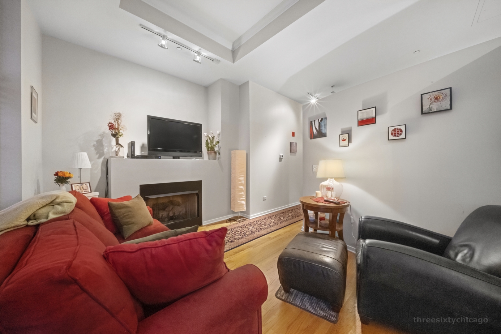 208 West Washington Street, Unit 1002 Chicago, IL 60606 - Photo 3 of 16 a living room with furniture and a fireplace