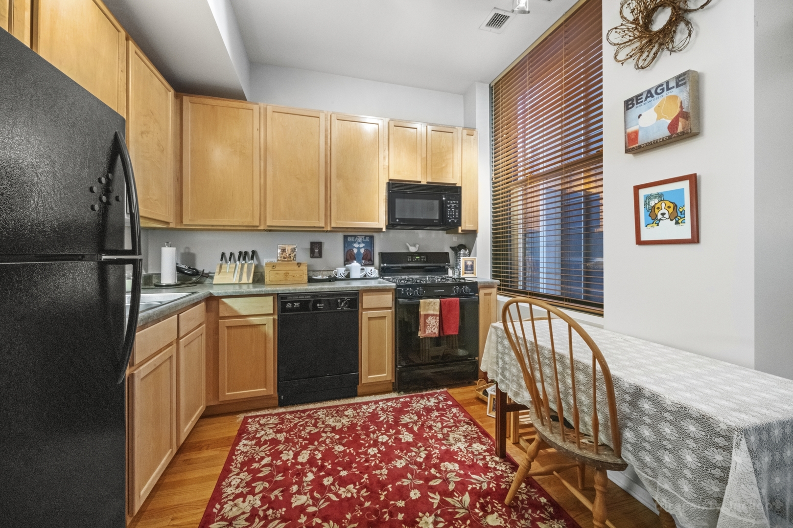 208 West Washington Street, Unit 1002 Chicago, IL 60606 - Photo 6 of 16 a kitchen with stainless steel appliances granite countertop a refrigerator and a stove top oven
