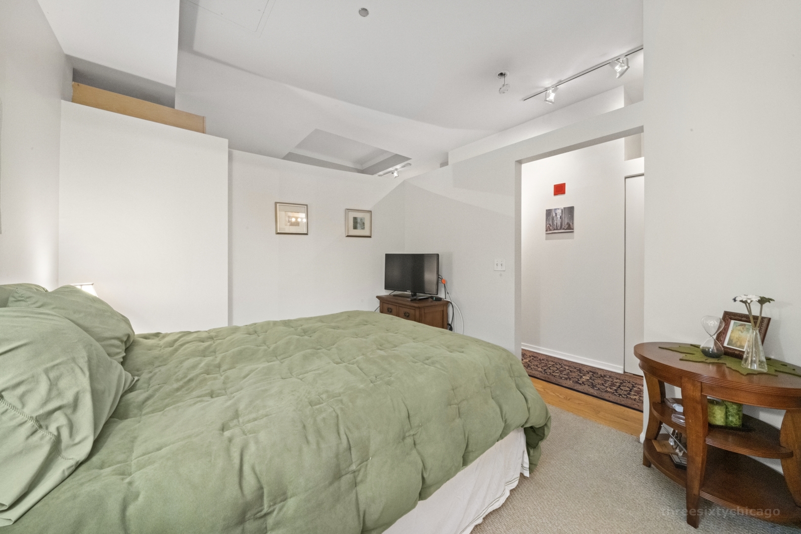 208 West Washington Street, Unit 1002 Chicago, IL 60606 - Photo 9 of 16 a bedroom with a bed and a chair