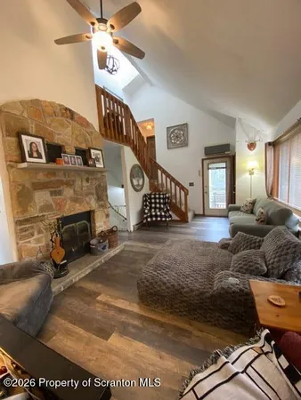 a living room with furniture and a fireplace