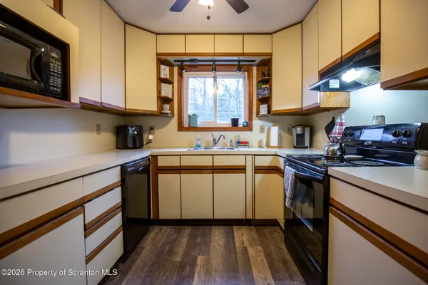 a kitchen with a sink cabinets stainless steel appliances and a window