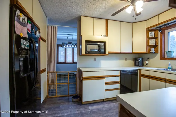 a kitchen with stainless steel appliances granite countertop a refrigerator a stove top oven a sink and dishwasher