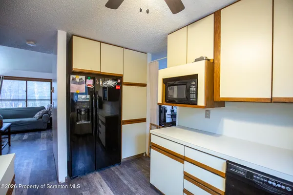 a kitchen with stainless steel appliances a microwave a stove and cabinets