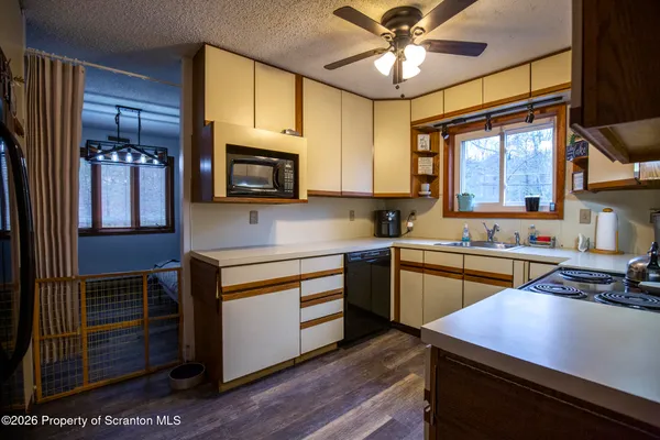 a kitchen with stainless steel appliances kitchen island granite countertop a stove a sink and a microwave