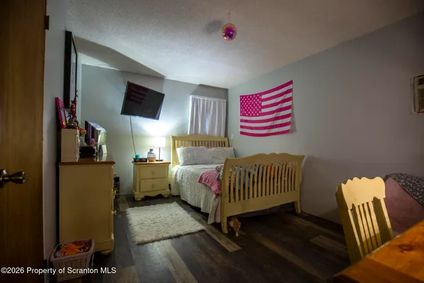 a bedroom with a bed and a television