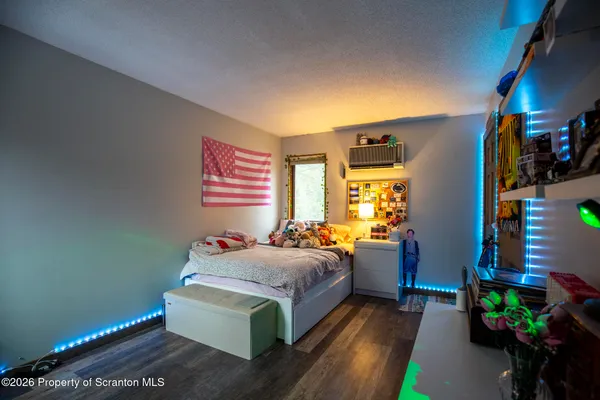 a bedroom with bed and window