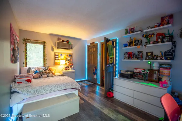a bedroom with bed and a book shelf