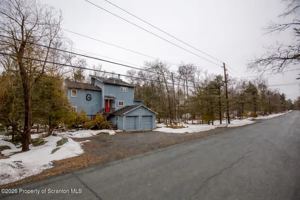 a front view of a house with a road