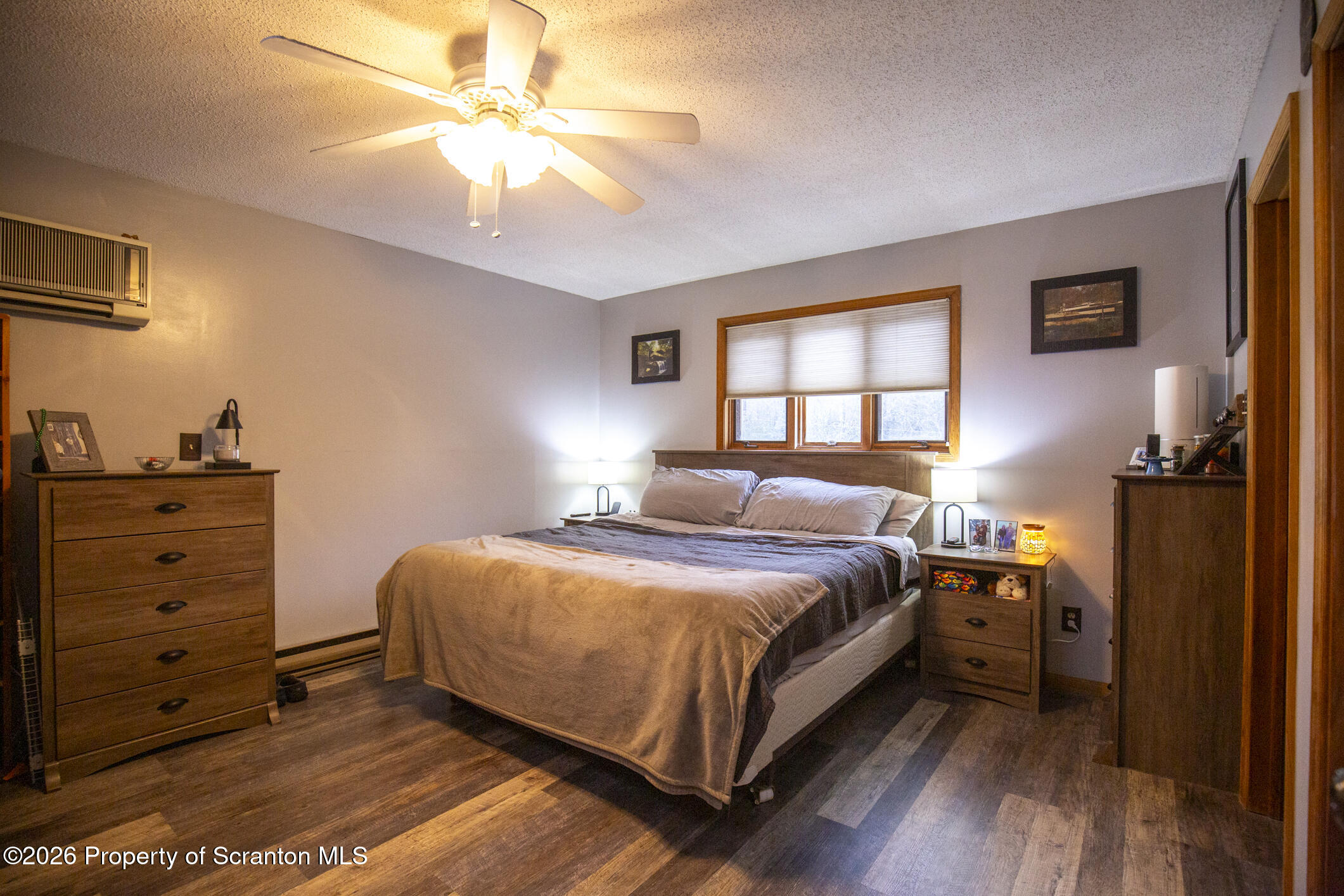 1290 Brookfield Road Lake Ariel, PA 18436 - Photo 32 of 47 a bedroom with a bed and a chandelier