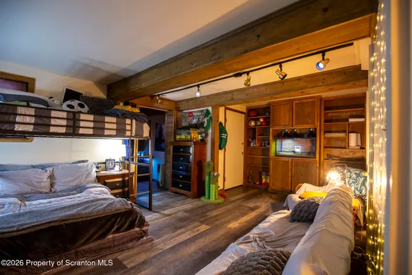 a bedroom with furniture and a flat screen tv