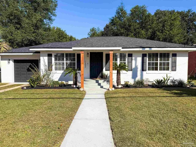 a front view of a house with garden