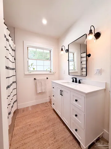 a bathroom with a double vanity sink mirror and