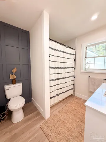 a bathroom with a toilet and a vanity