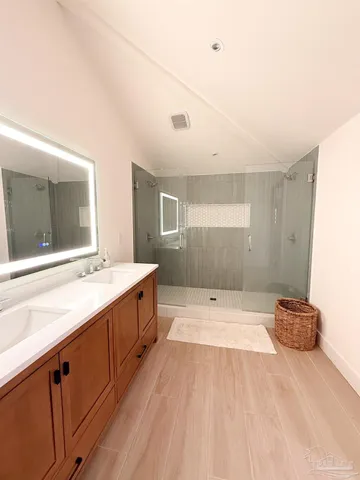 a bathroom with a sink mirror and a bathtub
