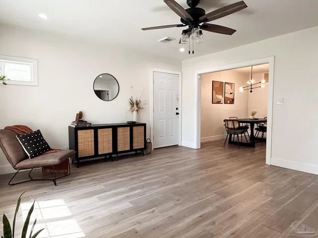 a view of a livingroom with a furniture hardwood floor and a ceiling fan