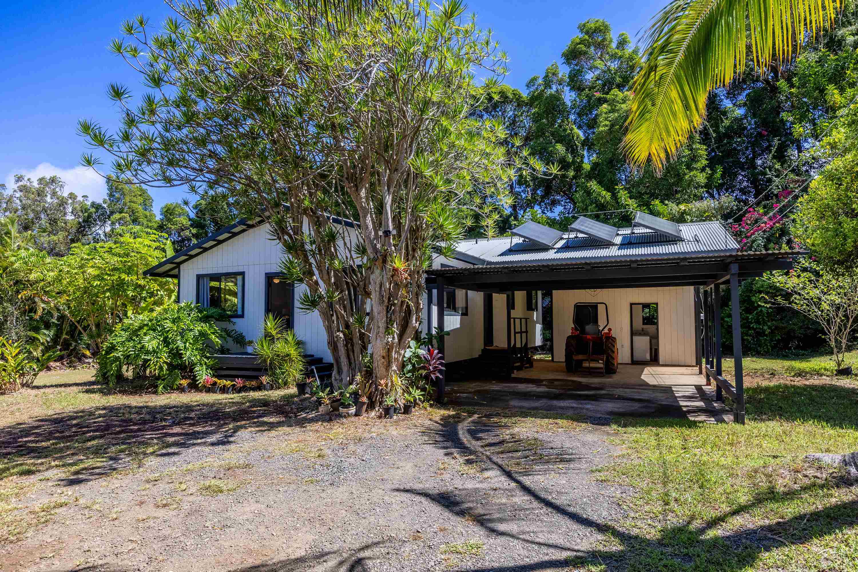 81 Kapuai Road Haiku, HI 96708 - Photo 1 of 50 a front view of a house with garden