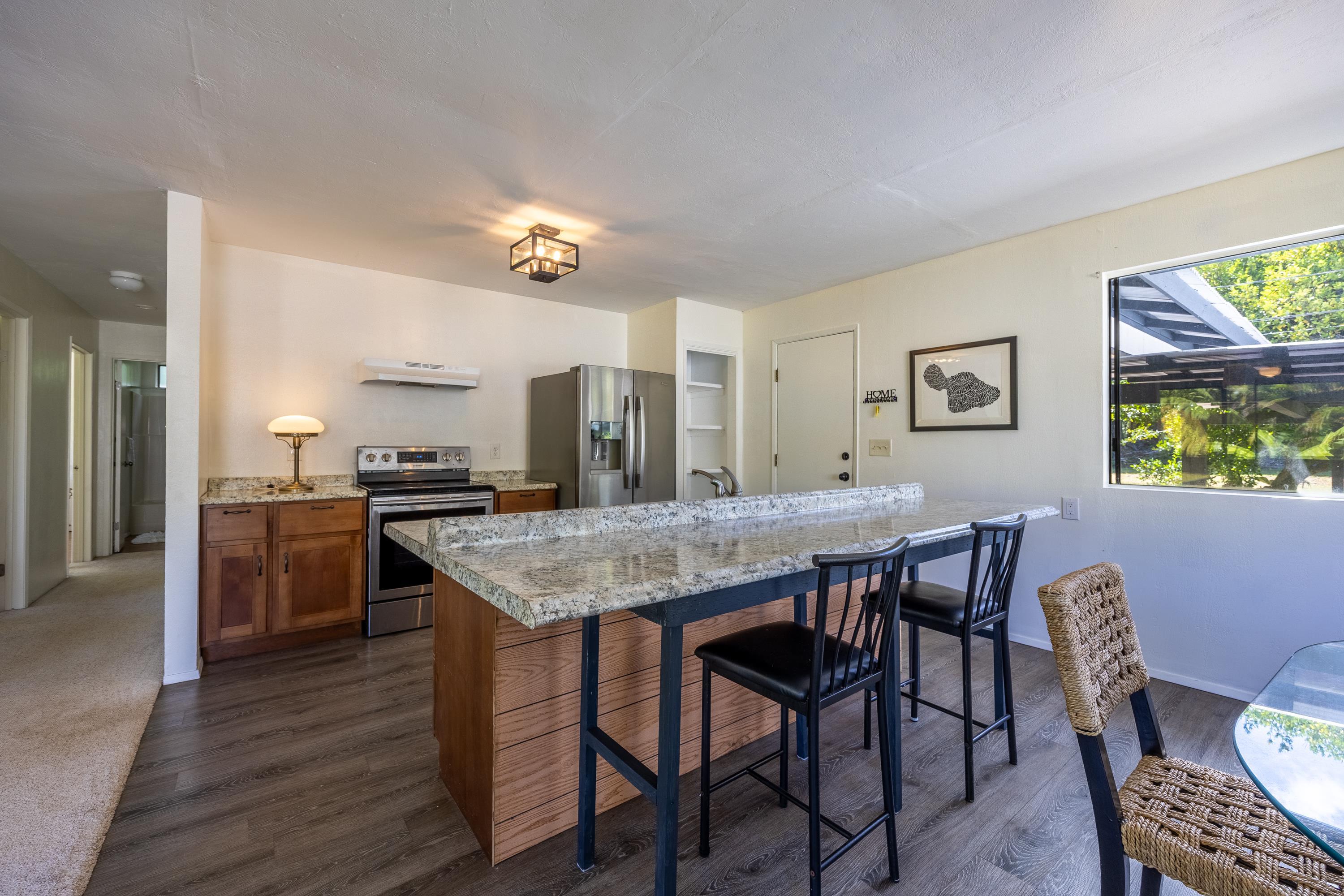 81 Kapuai Road Haiku, HI 96708 - Photo 17 of 50 a kitchen with a table and chairs in it