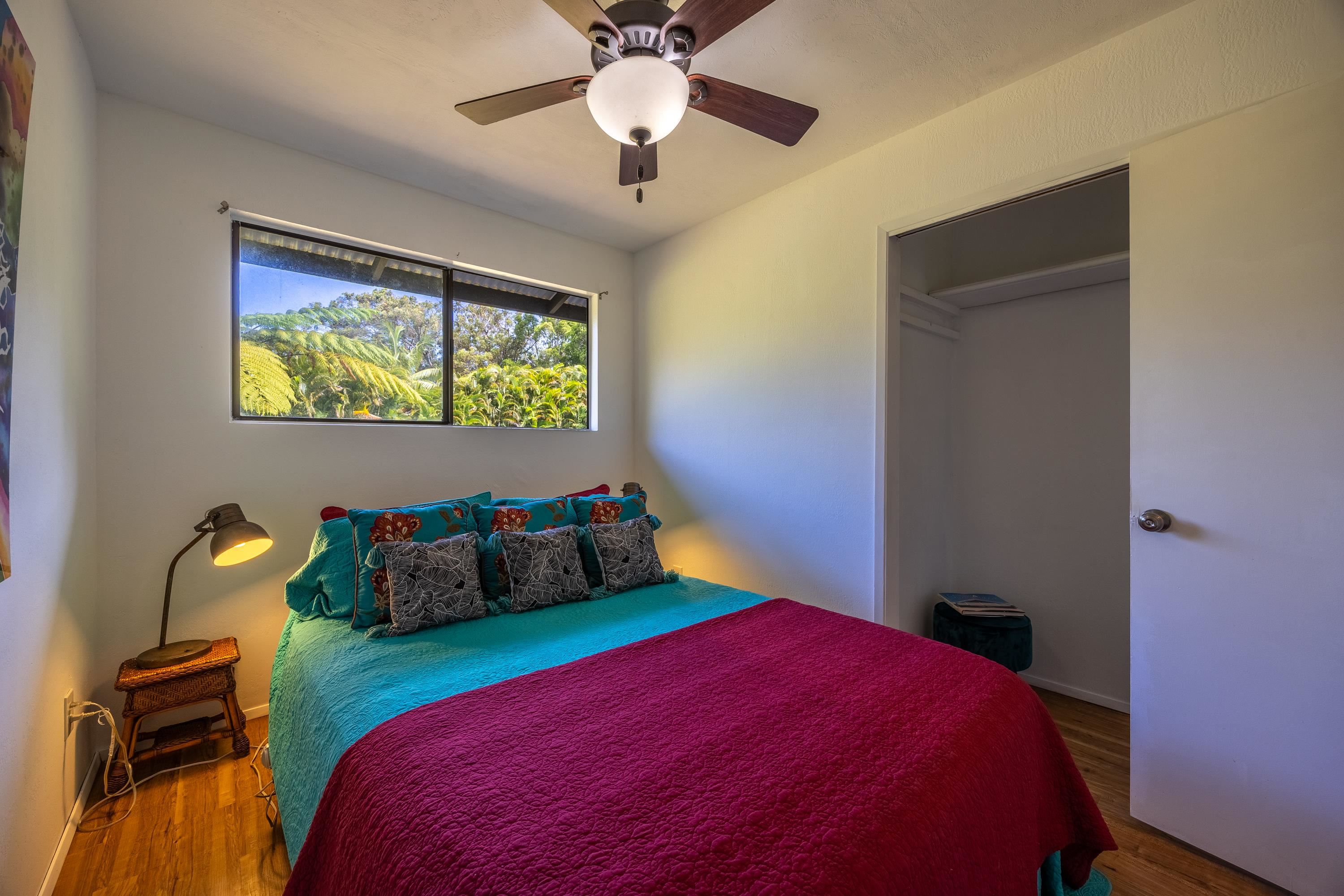 81 Kapuai Road Haiku, HI 96708 - Photo 23 of 50 a bedroom with a bed and a chandelier