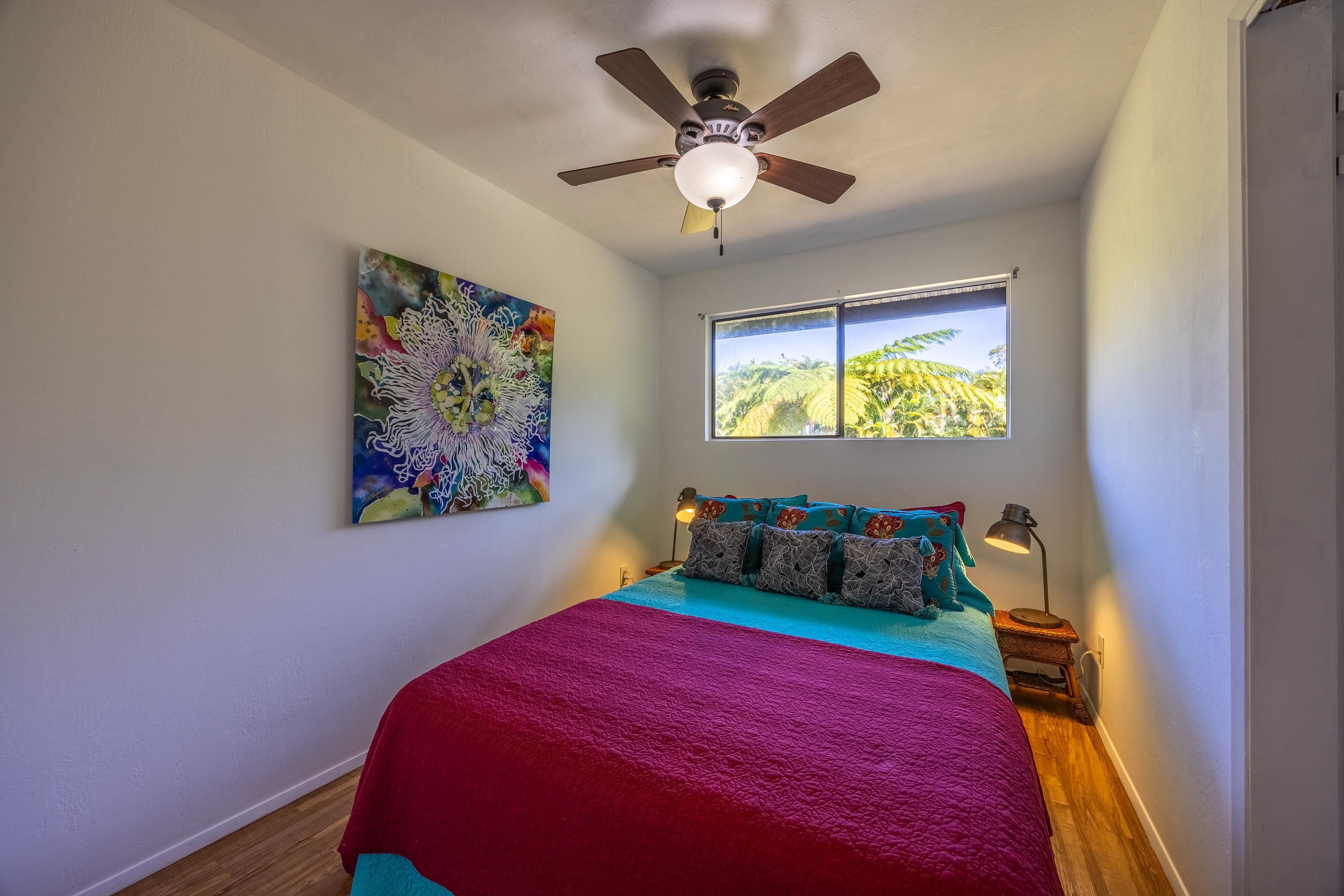 81 Kapuai Road Haiku, HI 96708 - Photo 24 of 50 a bedroom with a bed and a painting on the wall