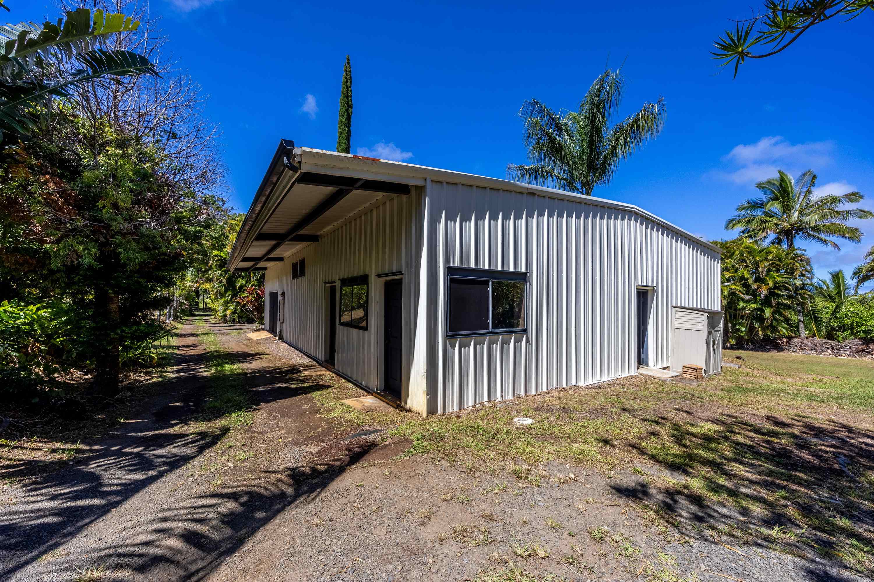 81 Kapuai Road Haiku, HI 96708 - Photo 5 of 50 a front view of a house with a yard