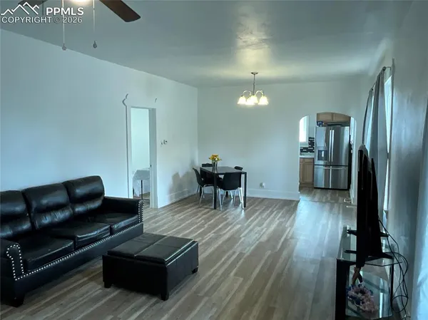 a living room with furniture and a wooden floor