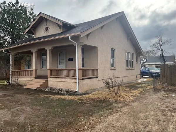 a view of a house with wooden fence
