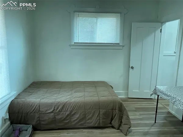a bedroom with a bed and window