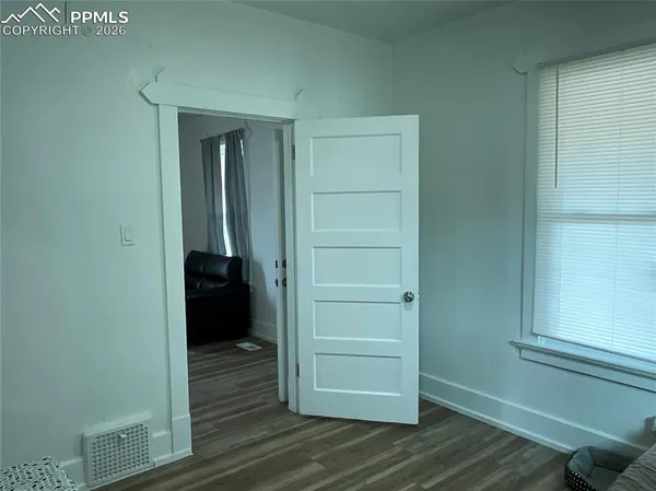 a view of walk in closet with wooden floor