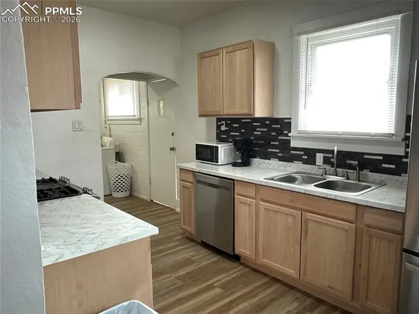 a kitchen with a sink stove and cabinets