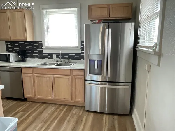 a kitchen with appliances cabinets and a counter top space