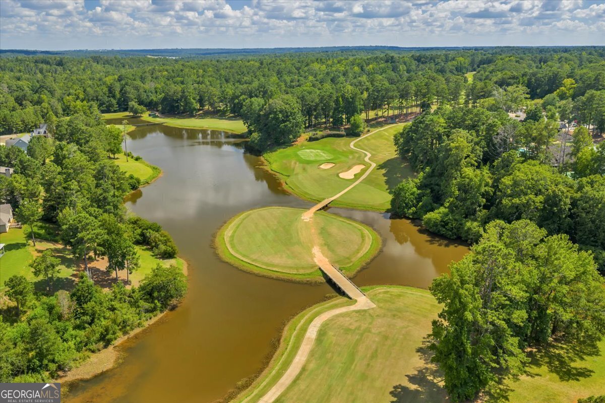 216 River Hills Ridge Road Macon, GA 31211 - Photo 9 of 13 a aerial view of a house with swimming pool and garden