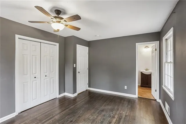 an empty room to hallway with wooden floor