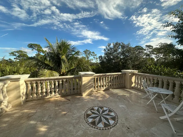 a view of balcony with furniture