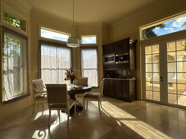 a dining room with furniture and window