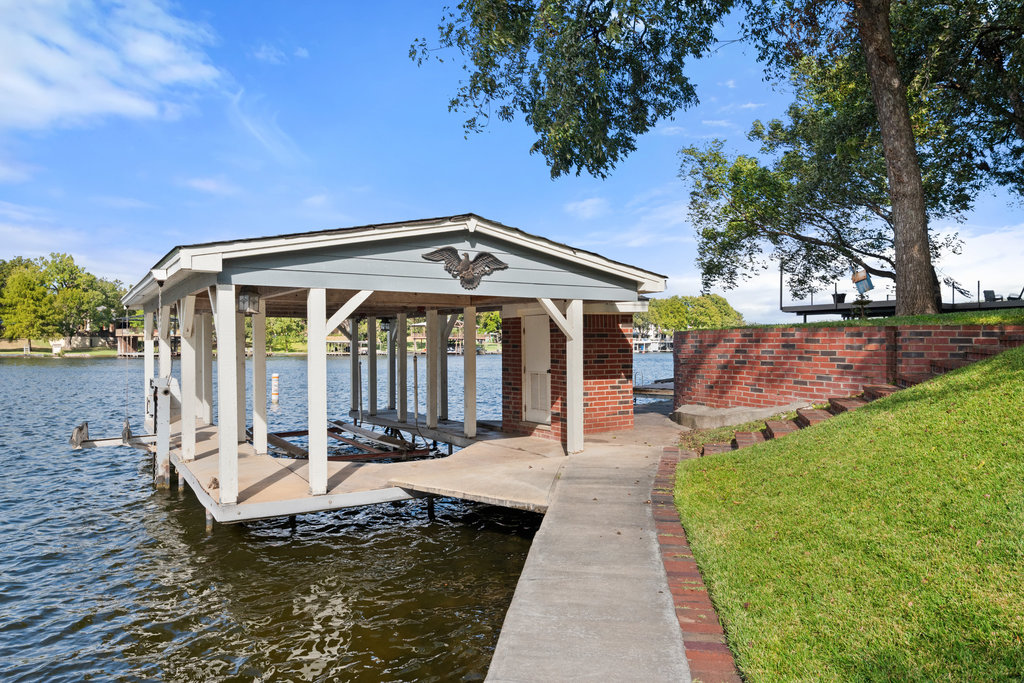104 River Ranch Road Kingsland, TX 78639 - Photo 35 of 39 Boat house featuring boat lift and a water view