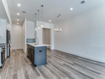 a large room with a lot of counter space and a refrigerator