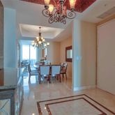 a view of a dining room with furniture and chandelier