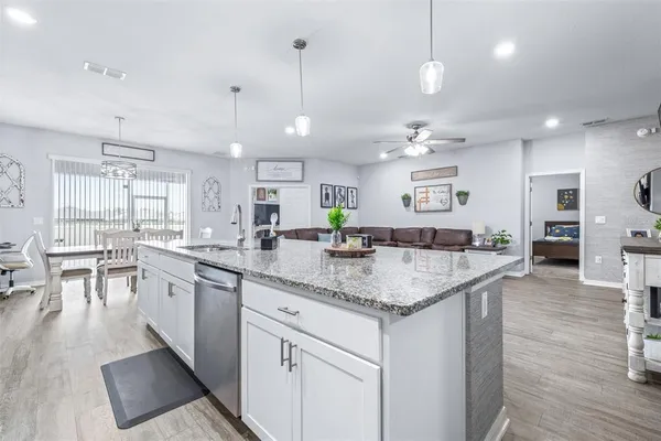 a kitchen with stainless steel appliances granite countertop wooden cabinets and a granite counter tops