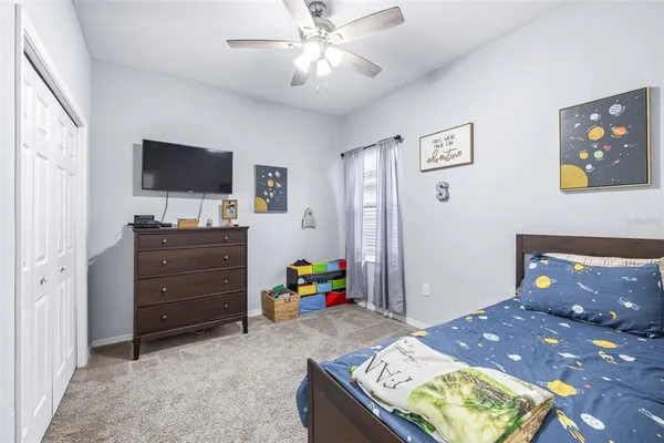 a bedroom with a bed and a chandelier