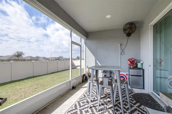 a view of house with backyard and glass windows
