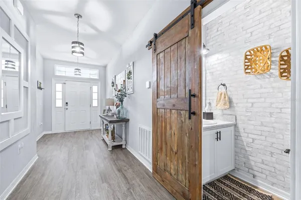 a very nice looking room with wooden floor and a bathroom