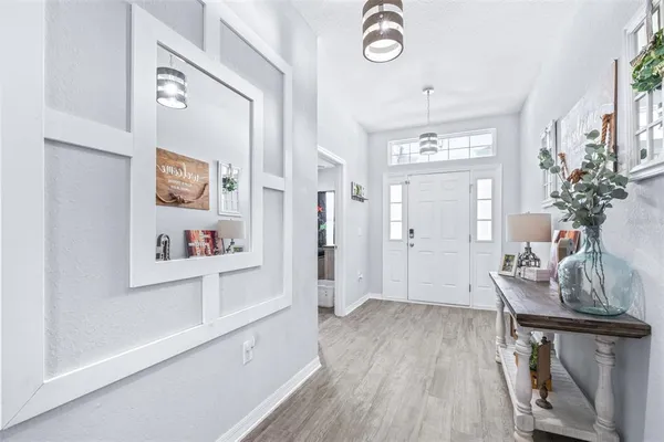 a hallway with furniture and wooden floor