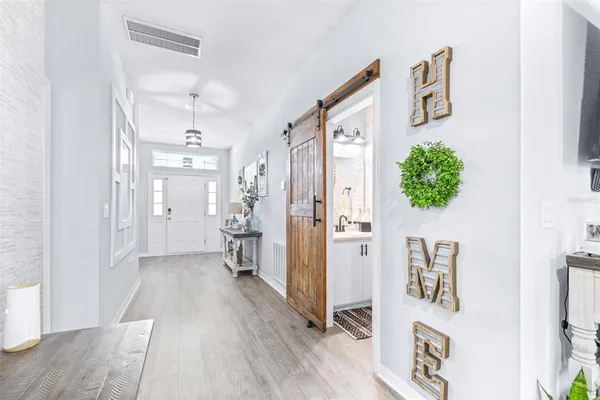a living room with lots of furniture and kitchen view
