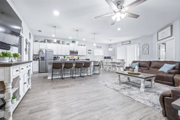 a living room with furniture and a wooden floor